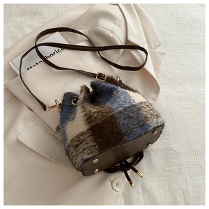 Chic plaid plush drawstring bucket bag with leather base and gold-tone studs