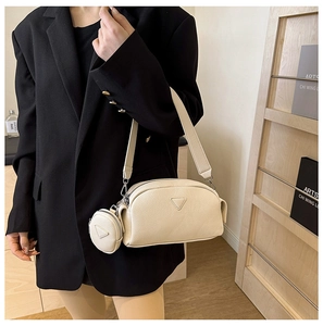 Detail of cream white faux leather shoulder bag with matching mini coin purse and canvas strap