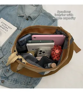 Macro view of spacious interior of canvas tote bag with striped lining and diverse items