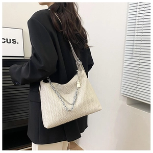 Detail of cream pleated PU shoulder bag with silver chain and cute rabbit charm