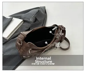 Detail view showing the main compartment and phone pocket of this brown PU crossbody bag