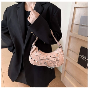 Close-up of pink PU leather handbag with metal studs and punk style eyelet details