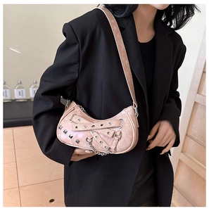 Pink patent leather shoulder bag with silver studs and chain details in punk style
