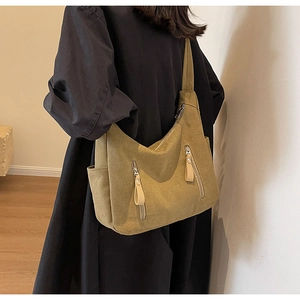 Detail view of khaki hobo canvas crossbody bag with multiple zip pockets and large capacity