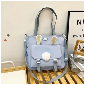 Fashionable light blue nylon handbag with cute rabbit ear decor and adjustable strap