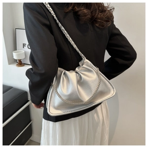 Detail of silver pleated cloud bag in lychee texture PU leather with dual chain straps