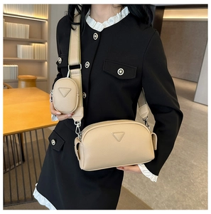 Close-up of beige lychee texture PU crossbody bag with detachable round mini coin purse