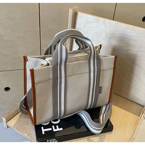 Fashion minimalist canvas crossbody tote bag with brown leather trim and striped handle
