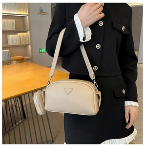 Fashionable apricot PU leather crossbody bag with lychee texture and round pouch charm