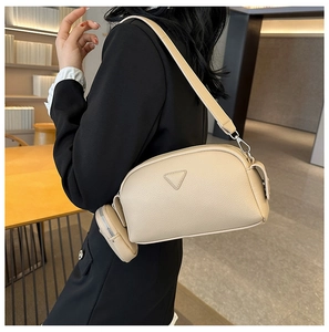 Chic beige textured faux leather crossbody bag with matching circular coin purse detail