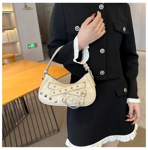 Close-up of cream PU leather shoulder bag with punk silver rivets and metal chain detail