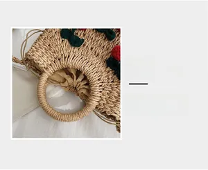 Detail magnification of woven straw handbag featuring cute knitted cherry charms and drawstring