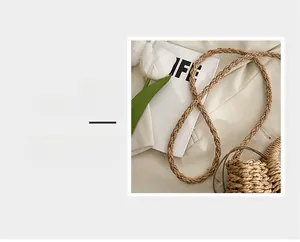 Detailed macro view of the handcrafted woven brown shoulder strap with natural texture