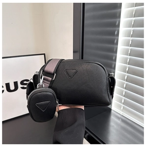 Minimalist black lychee texture PU leather crossbody bag with circular coin purse