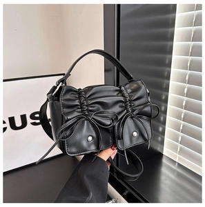 Chic black pleated PU handbag with bows and silver hardware for spring fashion 2024