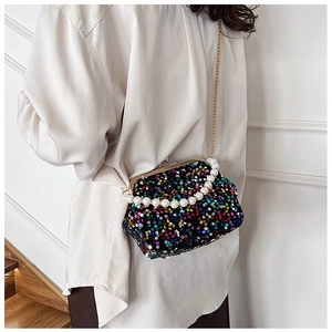 Detail of colorful sequin evening bag featuring gold metal clasp and pearl handle