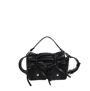 Black PU shoulder bag with pleated design and bow accents on white background