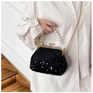 Macro view of vintage black sequin dinner bag with pearl handle and metal clasp