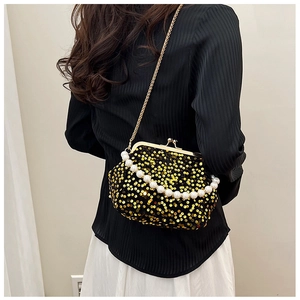 Detail of evening bag with gold sequins, faux pearl handle, and metal chain strap