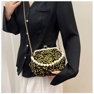 Detail of evening bag with gold sequins, pearl handle and detachable chain strap