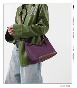 Close-up of a purple nylon handbag with leather trim and stylish color-contrast styling