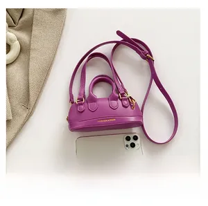 Purple PU leather mini crossbody bag size comparison with smartphone and shoulder strap