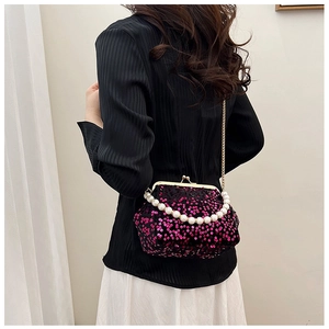 Detail of evening bag showing shiny pink sequins, pearl handle and gold chain strap