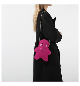 Detailansicht der rosa Lebkuchenmann-Filztasche mit goldener Kette am Model getragen