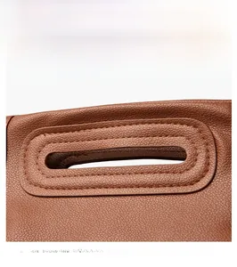 Detail of lychee pattern leather handbag featuring industrial gun color hardware accents