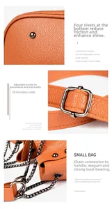 Détails du sac en cuir orange avec rivets métalliques, boucle de réglage et chaîne noire