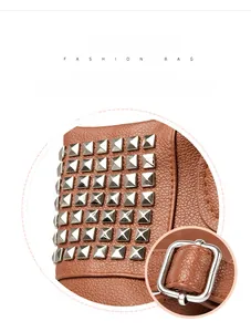 Detailed macro view of brown litchi leather bag with silver studs and metal buckle