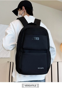 Detail of black water-resistant nylon backpack with wide straps and breathable mesh back