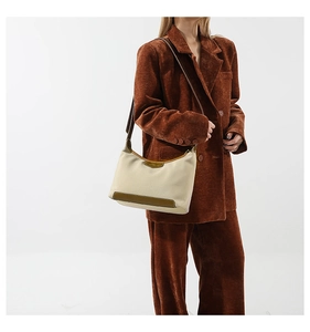 Fashionable beige nylon crossbody bag with brown leather trim and slim shoulder strap