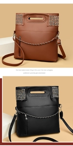 Detail of studded leather handbag showing silver rivets and metal chain decoration