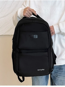Close-up of black nylon backpack featuring multi-layer zippers and side pockets