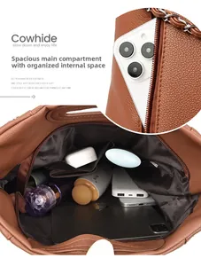 Detail view showing large internal capacity and leather texture of the brown cowhide bag