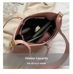 Pink pleated shoulder bag interior showing large capacity for phone and cosmetics