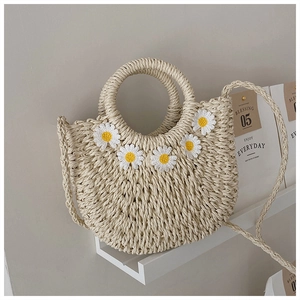 Beige woven straw moon bag with daisy applique and dual-style handles and straps