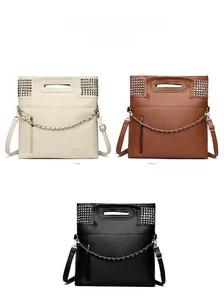 Detailed view of studded handbags in white, brown, and black with metal chain accents