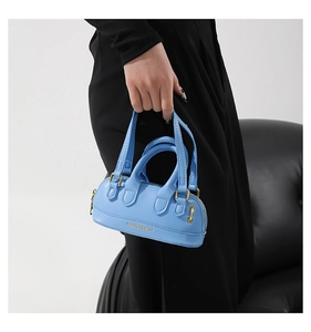 Detail of light blue PU leather mini handbag with gold hardware and fashion lettering