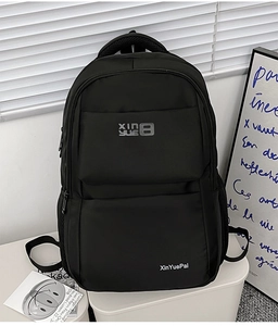 Detail view of the black water-resistant nylon backpack with side mesh pocket and zip pockets