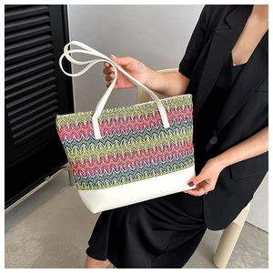 Detail of colorful woven wave pattern with white leather trim on a stylish tote bag