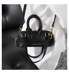 Detail of black PU leather Boston bag with gold hardware and Fashion & Bags text logo