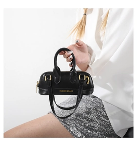 Fashionable black mini Boston bag in glossy PU leather with adjustable shoulder strap