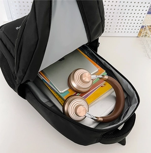 Detail view of black nylon backpack interior showing large capacity for tablet and books