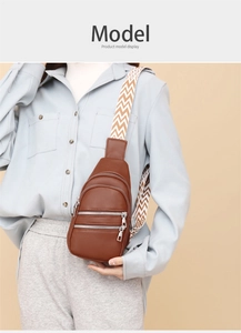 Close-up of brown litchi pattern PU leather crossbody bag with three parallel silver zippers