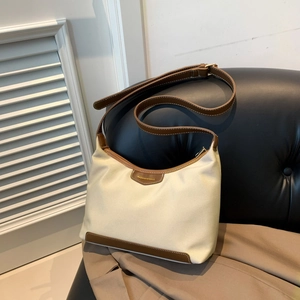 Minimalist beige nylon crossbody bag with brown leather trim and adjustable shoulder strap