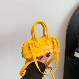 Fashionable bright yellow PU leather mini handbag with crossbody strap and gold hardware