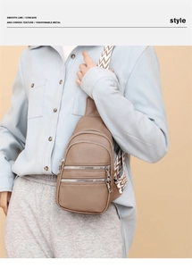 Detail of coffee litchi grain PU leather crossbody bag with woven shoulder strap
