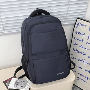 Modern navy blue nylon backpack with minimalist design and white brand logo for women